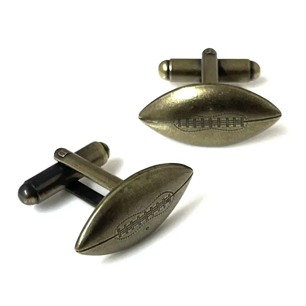 A pair of football-shaped cufflinks in an antique brass finish