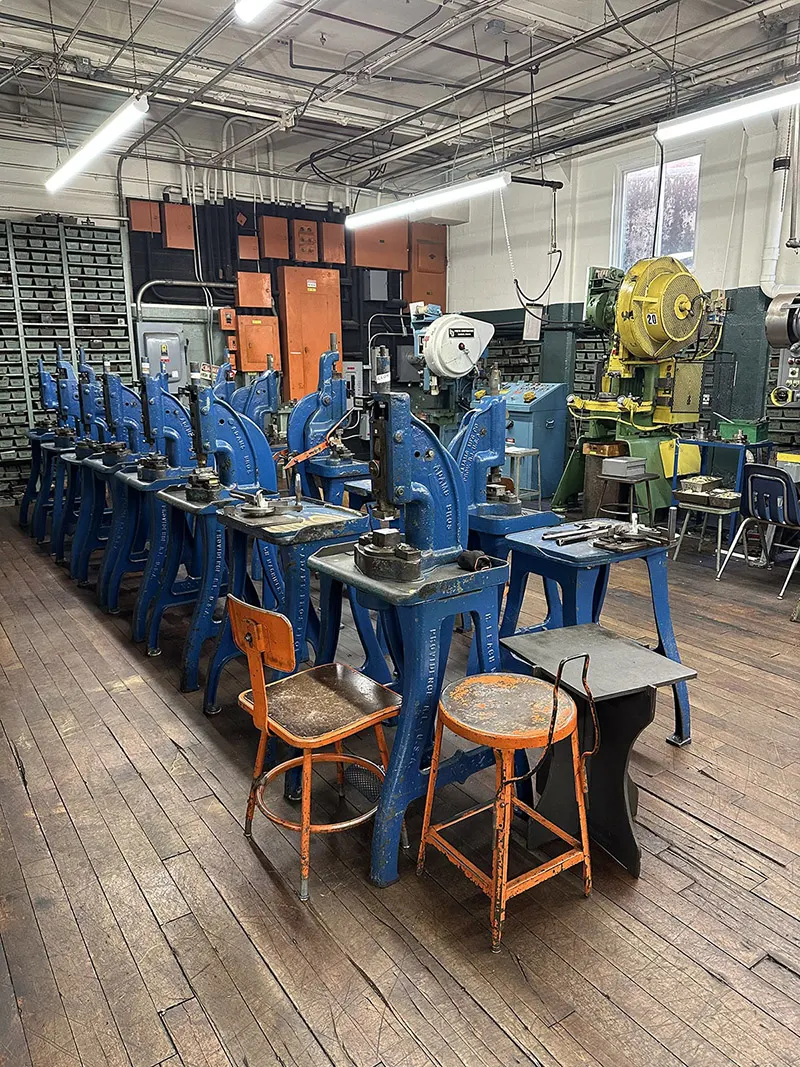 A row of blue foot presses for secondary operations