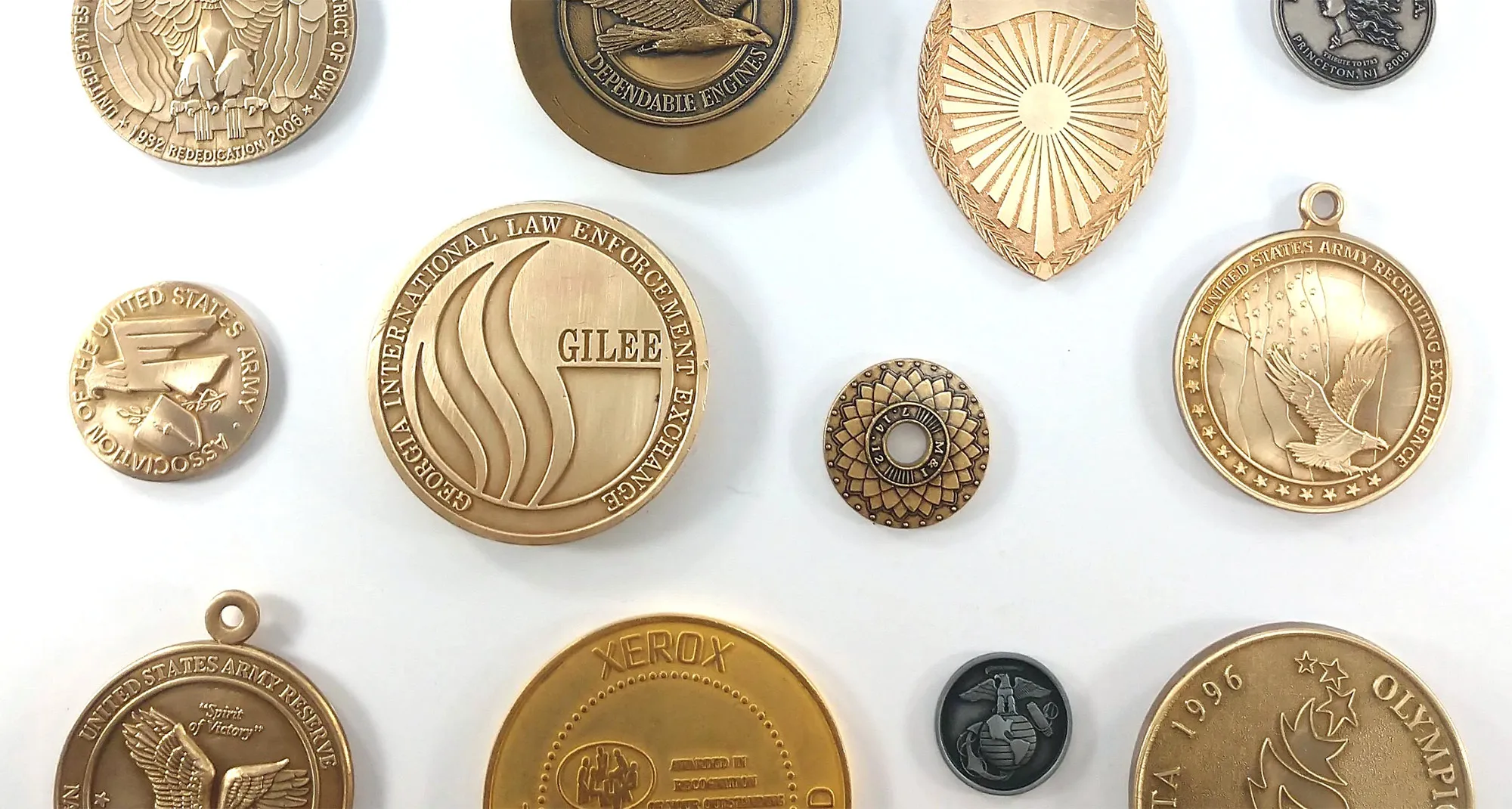 An assortment of die-struck medallions and pendants in gold and antique finishes