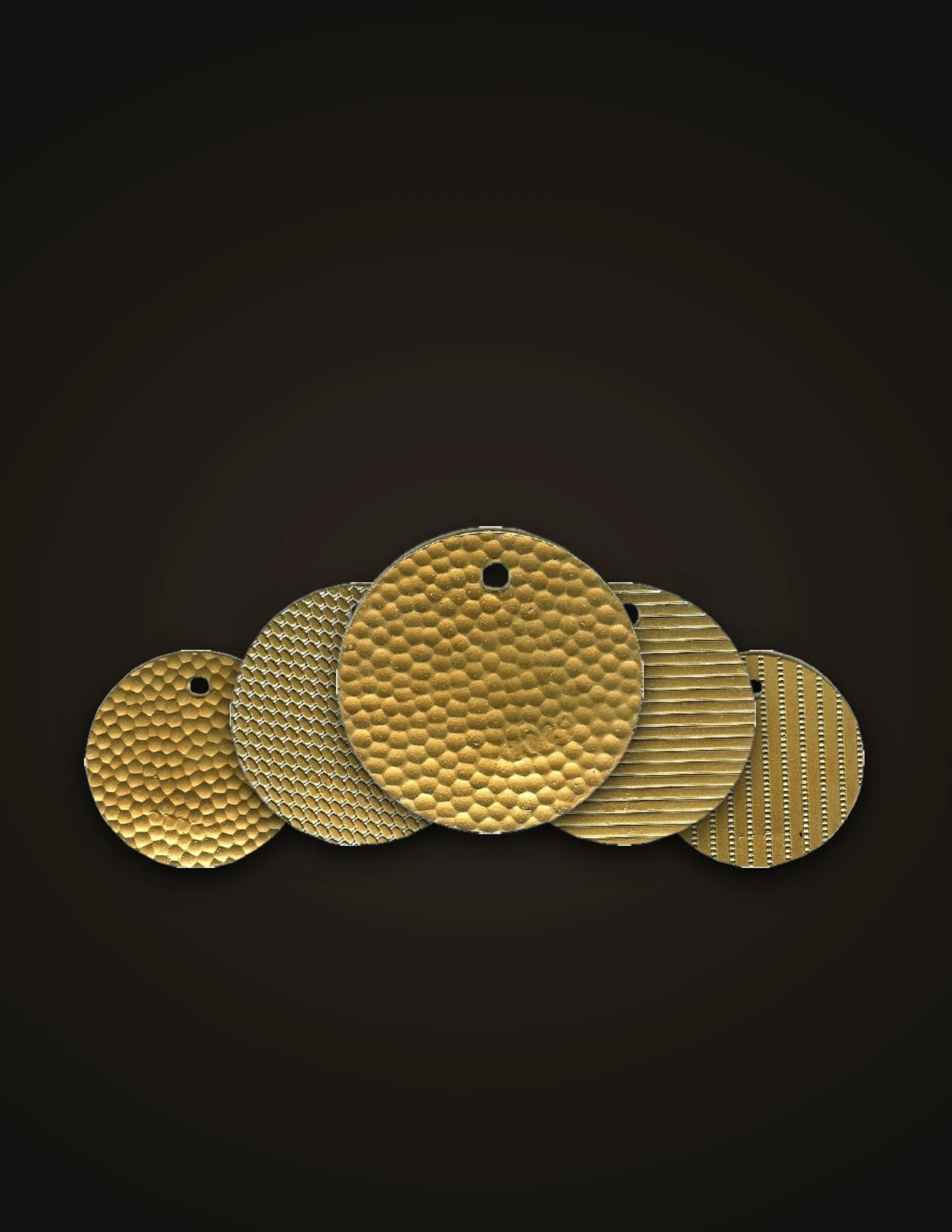 Five embossed brass pattern stock discs with hammered, diamond, ribbed and striped textures, on a dark background
