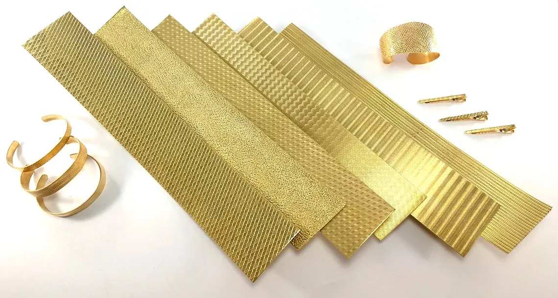 Strips of embossed brass pattern stock with a finished cuff made from it